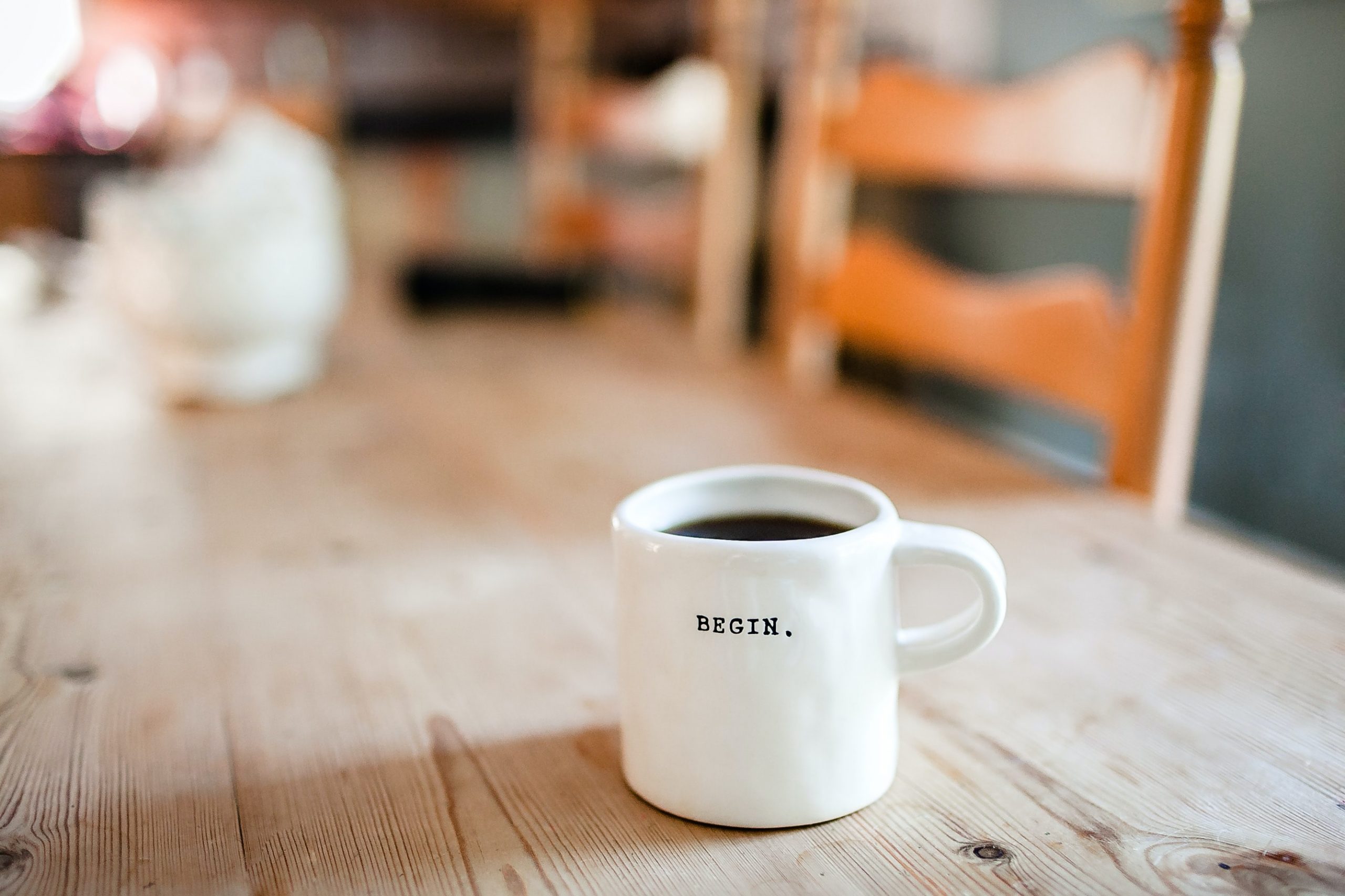 a white mug with a word begin on it